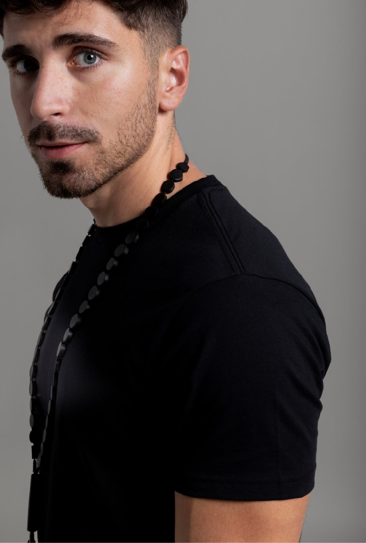 A man wearing a black crew neck t-shirt.