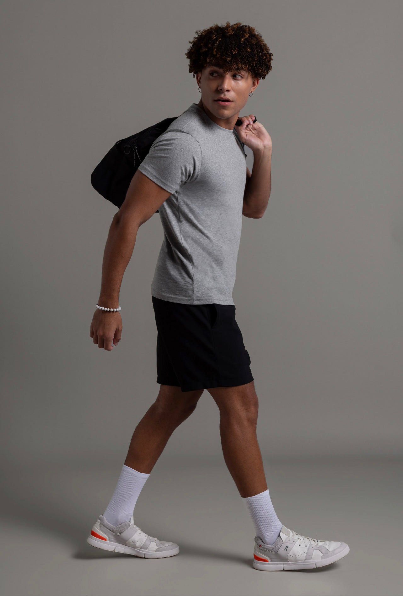 Men’s heather grey tee walking side pose