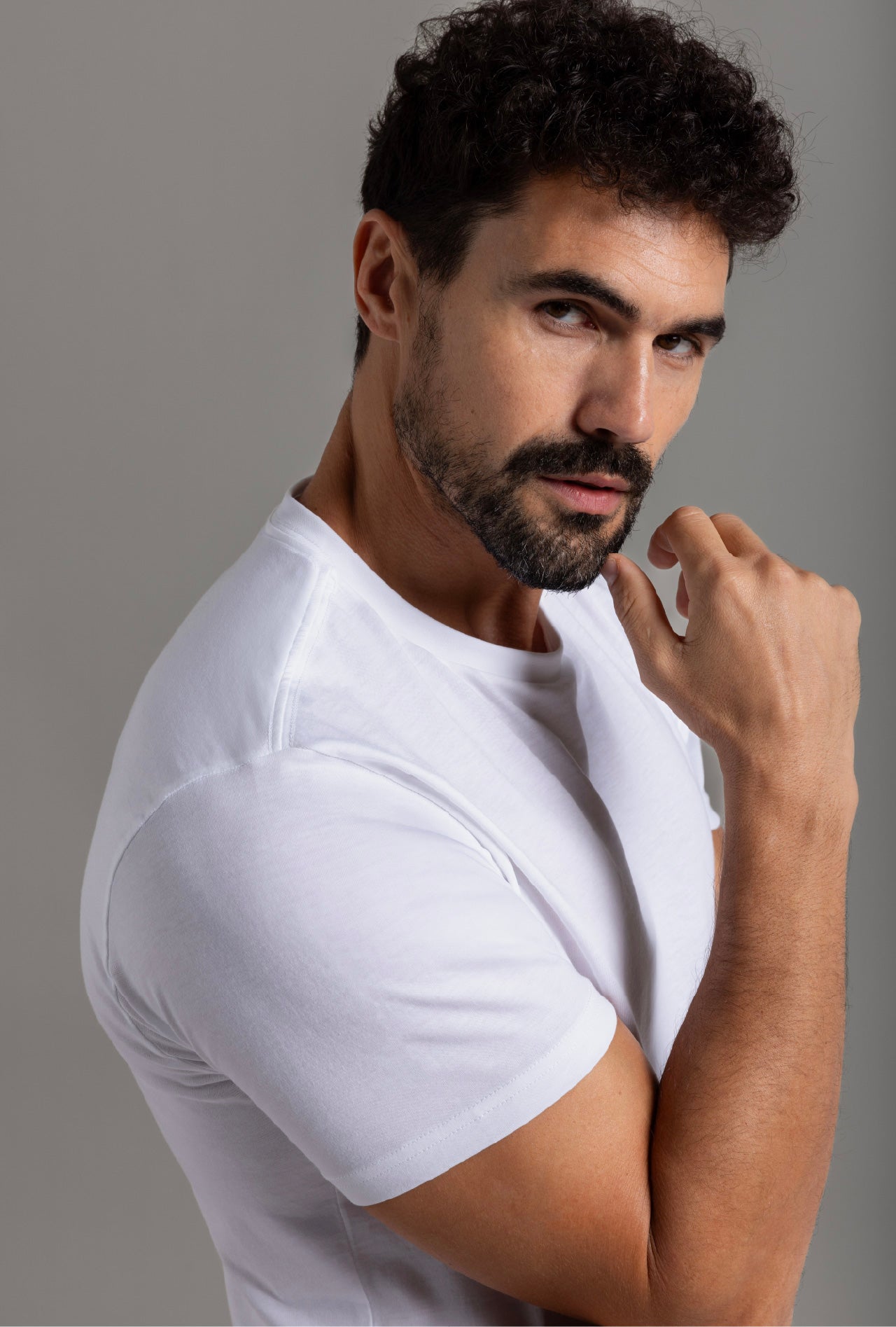 A male model wearing a white Pima cotton T-shirt.