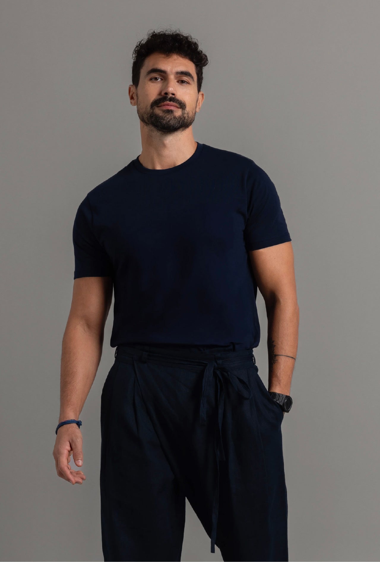 A man wearing a midnight blue crew neck t-shirt and matching pants.